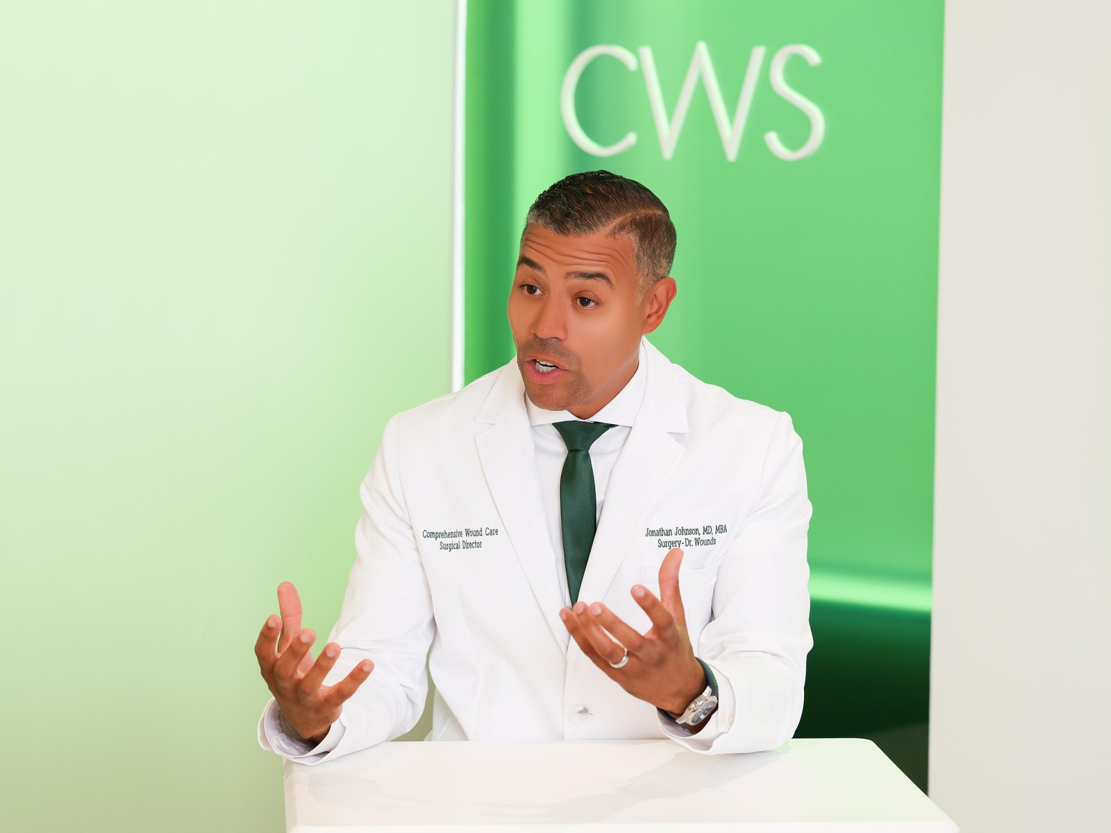 Jonathan Johnson, MD, MBA, CWSP, FAPWCA, talking a patient through a wound-care plan at CWS