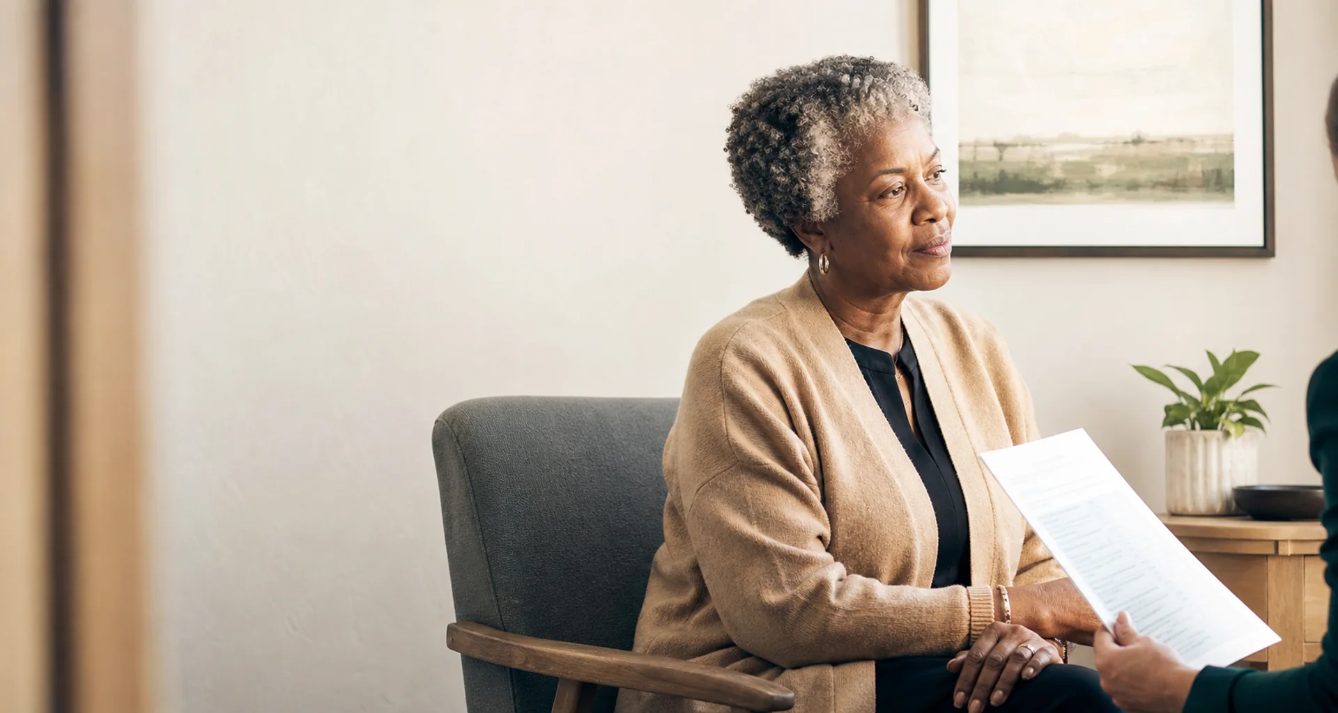 A wound provider reviewing a case with a patient in a home setting
